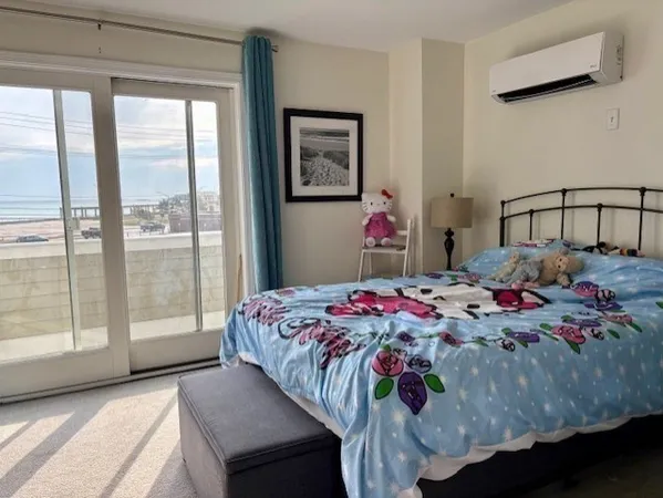 a bedroom with a bed and a large window