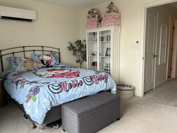 a bedroom with a bed and a painting on the wall