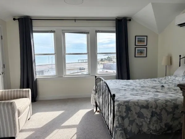 a bedroom with a bed and a window with balcony view