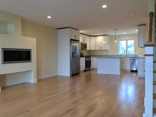 a kitchen with stainless steel appliances granite countertop a stove and a refrigerator