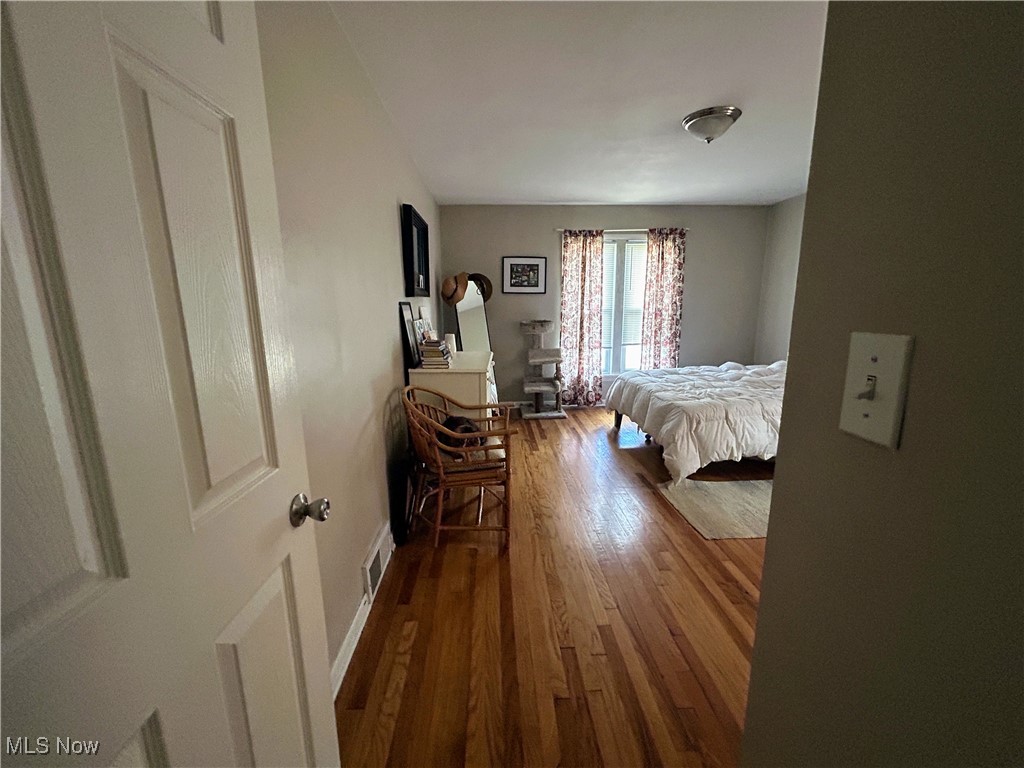 13678 Cedar Road Cleveland, OH 44118 - Photo 5 of 24 Bedroom #1 (lower unit) with dark wood-style flooring, baseboards, and visible vents