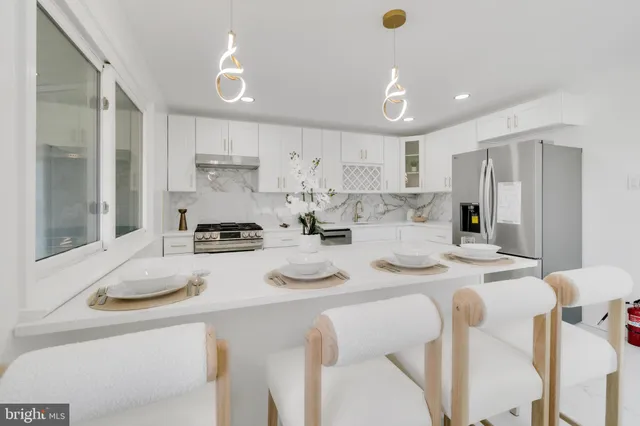 a kitchen with stainless steel appliances kitchen island granite countertop a sink and cabinets