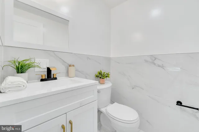 a bathroom with a sink a toilet and a shower