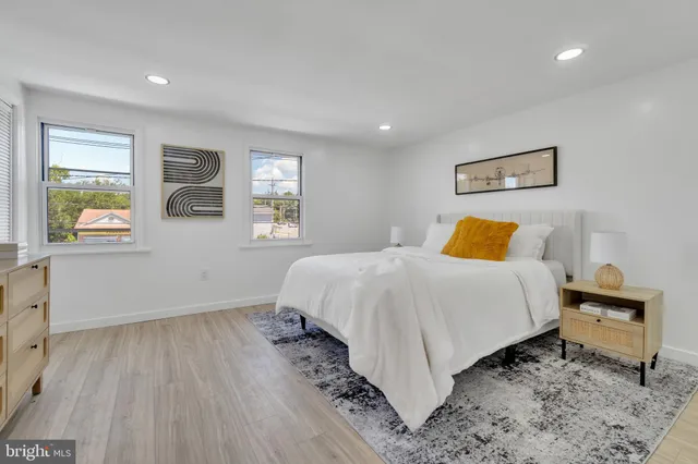 a bedroom with a bed and a painting on the wall