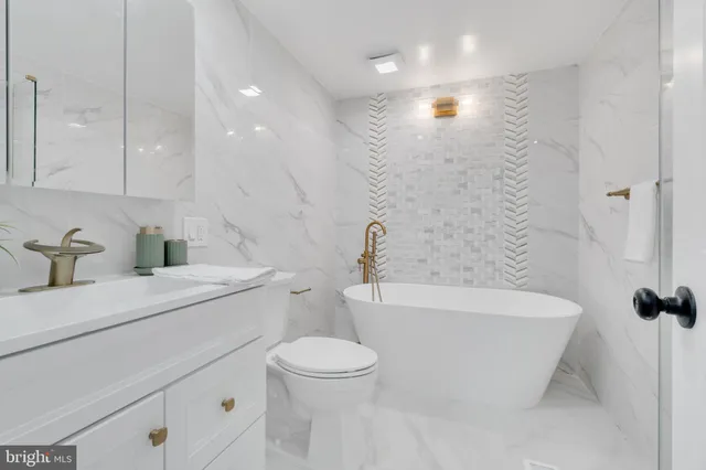 a bathroom with a sink a toilet and a bathtub