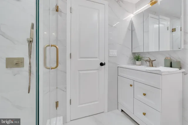 a bathroom with a shower sink and cabinets