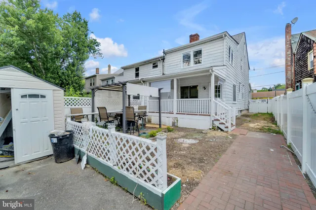 a view of a house with wooden fence