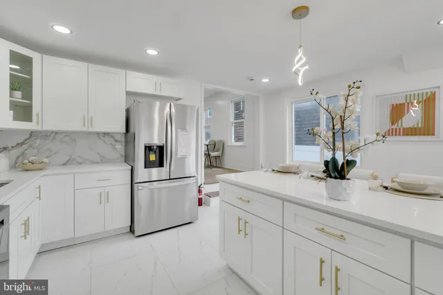 a kitchen with white cabinets and white appliances