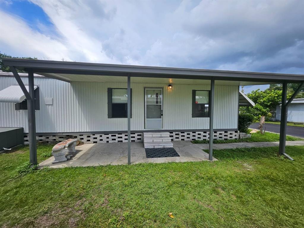 6445 Belle Terre Road New Port Richey, FL 34653 - Photo 1 of 16 front view of house with a yard