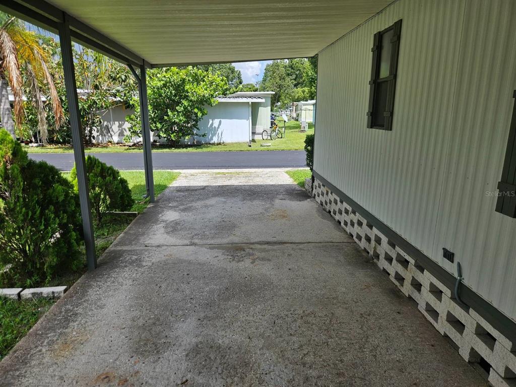 6445 Belle Terre Road New Port Richey, FL 34653 - Photo 2 of 16 a view of a porch with wooden floor and stairs