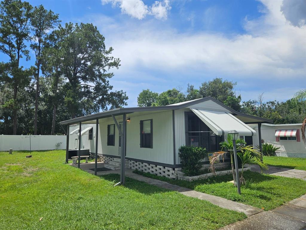 6445 Belle Terre Road New Port Richey, FL 34653 - Photo 4 of 16 a view of a yard in front of house