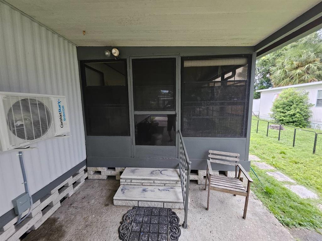 6445 Belle Terre Road New Port Richey, FL 34653 - Photo 5 of 16 a room with furniture a window and a rug