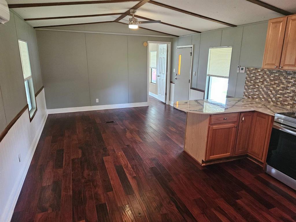 6445 Belle Terre Road New Port Richey, FL 34653 - Photo 9 of 16 wooden floor in an empty room with a window