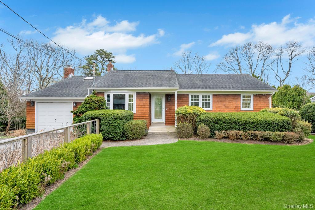 a front view of a house with a yard and outdoor seating
