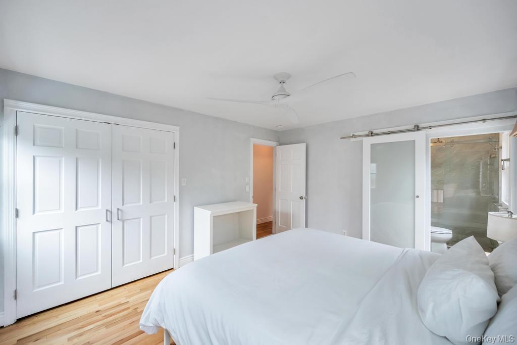 8 Lovell Road Hampton Bays, NY 11946 - Photo 14 of 20 a bedroom with a bed and a shower