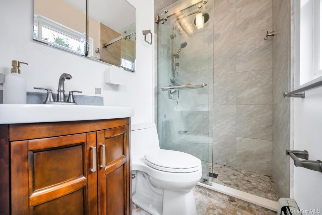 8 Lovell Road Hampton Bays, NY 11946 - Photo 15 of 20 a bathroom with a sink a toilet and shower