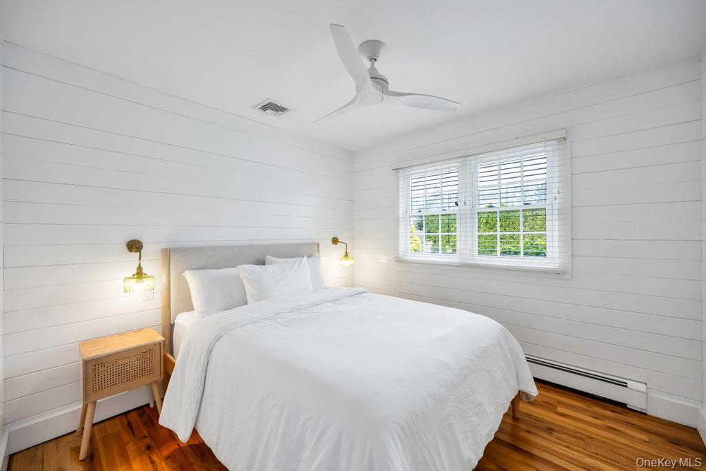 8 Lovell Road Hampton Bays, NY 11946 - Photo 16 of 20 a bedroom with a bed and a window