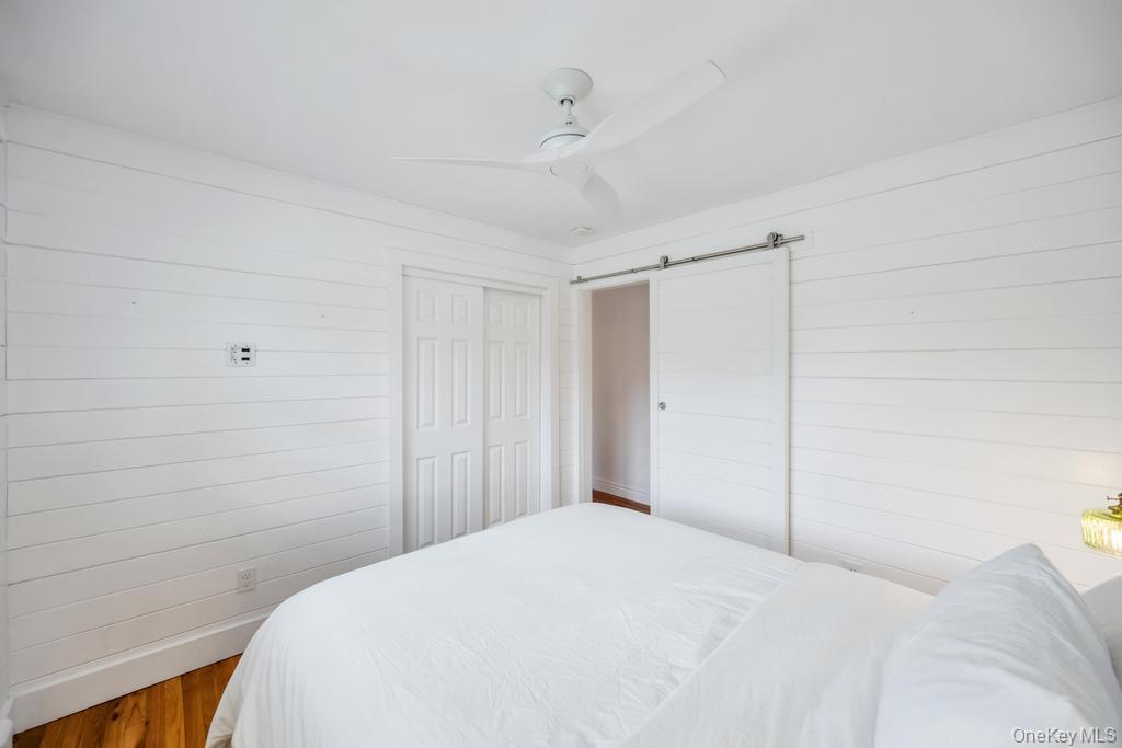 8 Lovell Road Hampton Bays, NY 11946 - Photo 18 of 20 a bedroom with a bed and a window