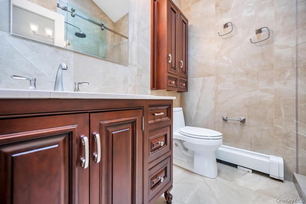 8 Lovell Road Hampton Bays, NY 11946 - Photo 19 of 20 a bathroom with a sink a toilet and shower
