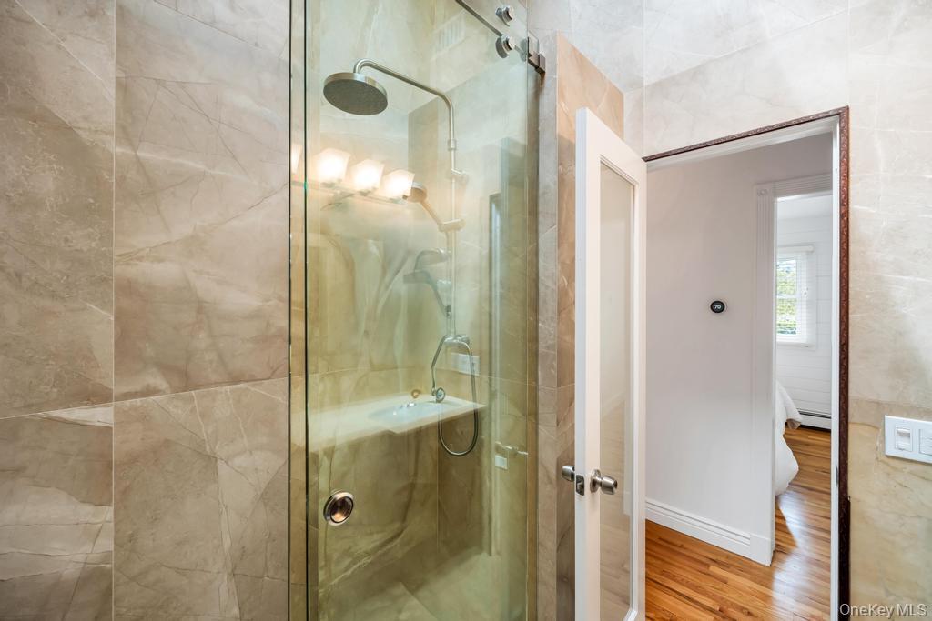 8 Lovell Road Hampton Bays, NY 11946 - Photo 20 of 20 a bathroom with a glass shower door