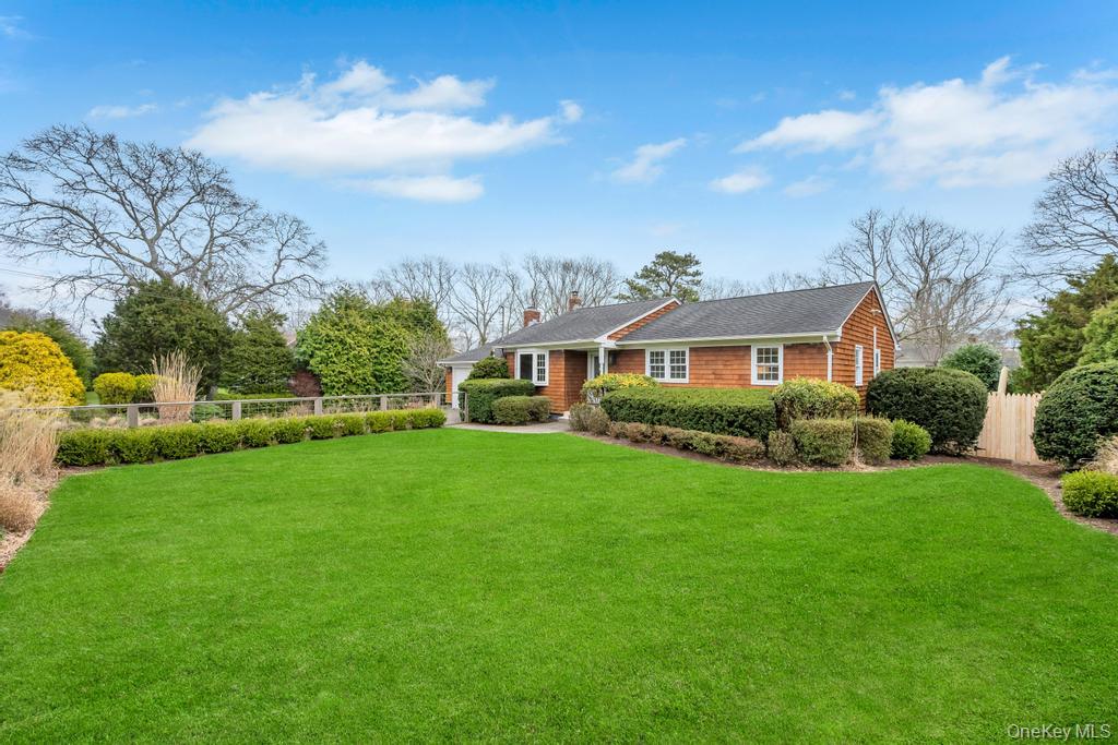 8 Lovell Road Hampton Bays, NY 11946 - Photo 2 of 20 a front view of a house with garden