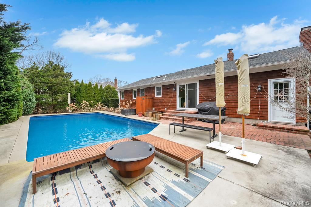 8 Lovell Road Hampton Bays, NY 11946 - Photo 3 of 20 a view of a patio with couches table and chairs with wooden floor and fence