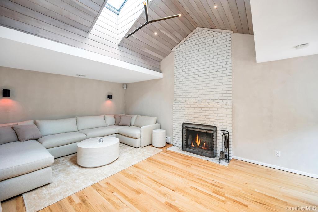 8 Lovell Road Hampton Bays, NY 11946 - Photo 6 of 20 a living room with furniture and a fireplace