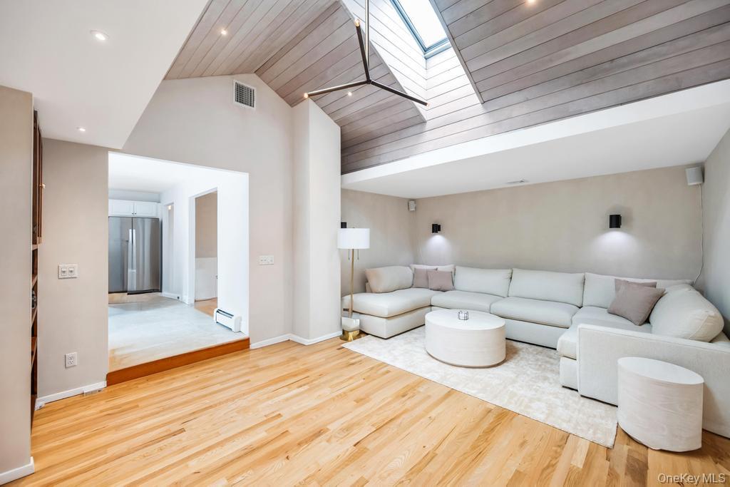 8 Lovell Road Hampton Bays, NY 11946 - Photo 7 of 20 a living room with furniture and a wooden floor