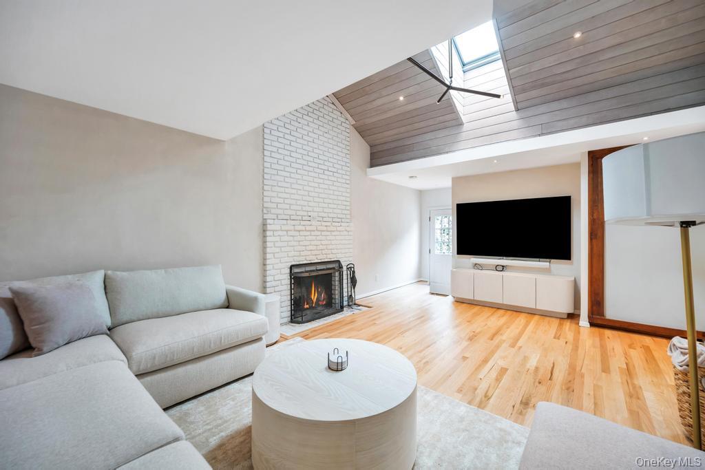 8 Lovell Road Hampton Bays, NY 11946 - Photo 8 of 20 a living room with furniture and a flat screen tv