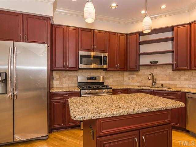 10108 Old Warden Road Raleigh, NC 27615 - Photo 5 of 25 The kitchen was remodeled with granite countertops, new cabinets, new tile backsplash and new stainless steel appliances. Kitchen