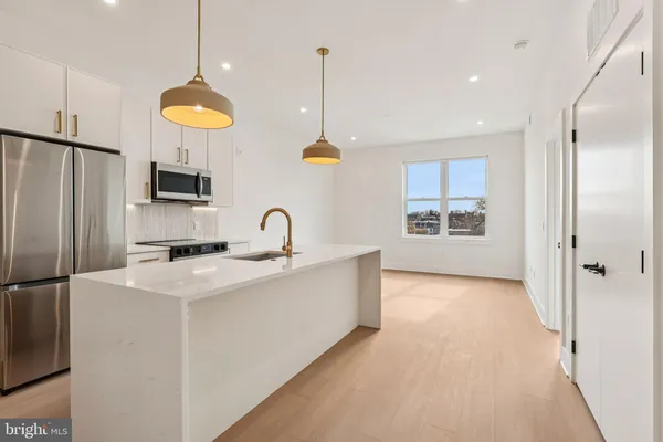 a kitchen with a sink and a refrigerator