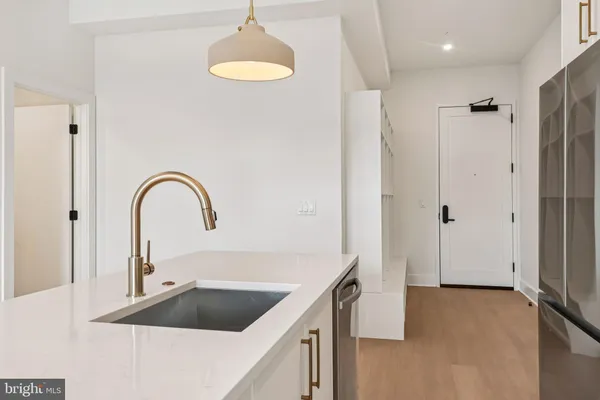 a kitchen with a refrigerator and a sink