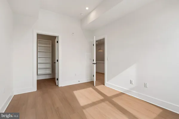 a view of walk in closet with empty racks