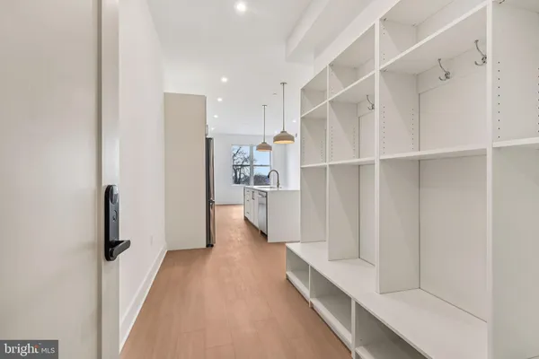 a view of a kitchen with refrigerator and a sink