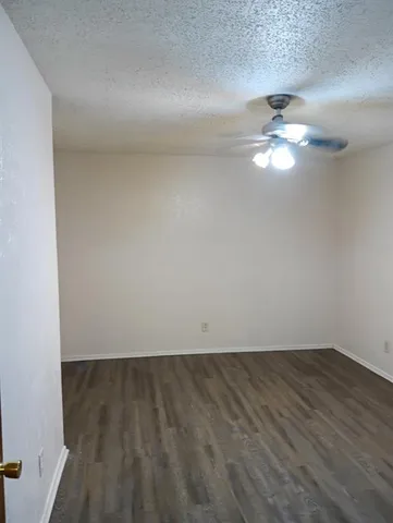 an empty room with wooden floor and closet