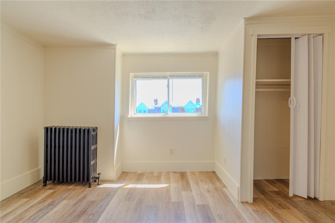 820 North 5th Street Allentown, PA 18102 - Photo 34 of 39 A quiet room featuring radiant heat, wide plank flooring, and a convenient closet for optimal organization.