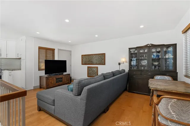 a living room with fireplace furniture and a potted plant