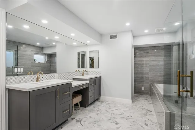 a bathroom with a toilet sink vanity and mirror