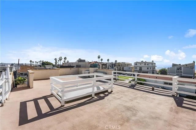 a view of a terrace with lawn chairs and stove