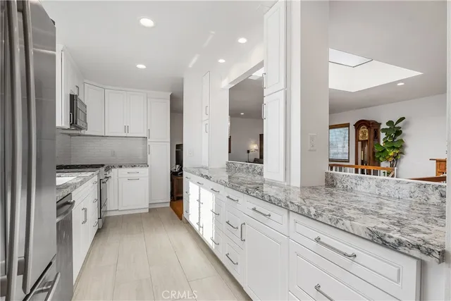 a view of a hallway with kitchen area