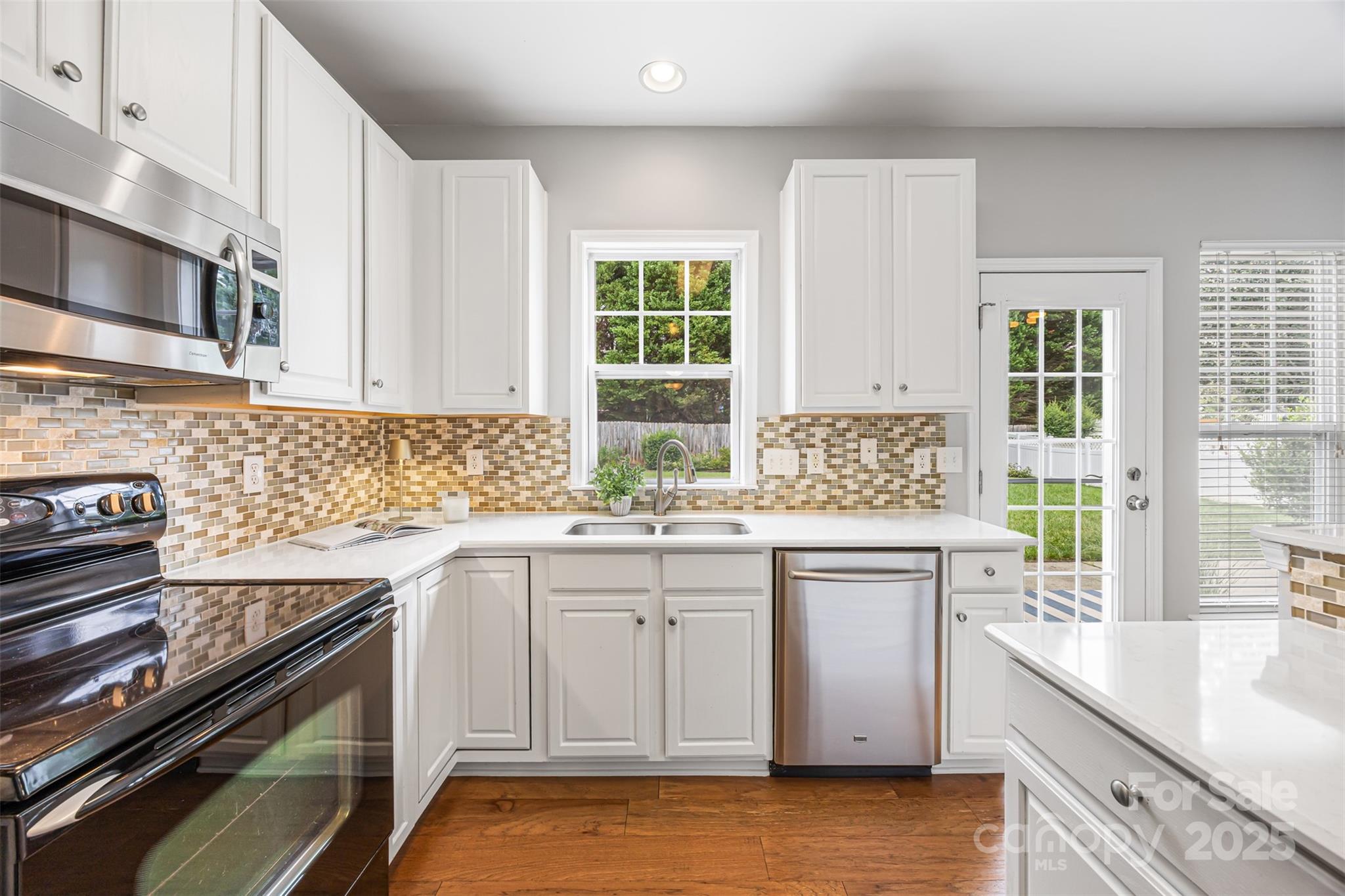317 Sand Paver Way Fort Mill, SC 29708 - Photo 10 of 27 a kitchen with a sink stove and cabinets