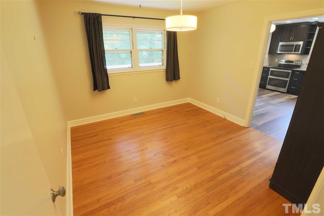 3501 Cranston Road Garner, NC 27529 - Photo 11 of 18 a view of an empty room with wooden floor and a window