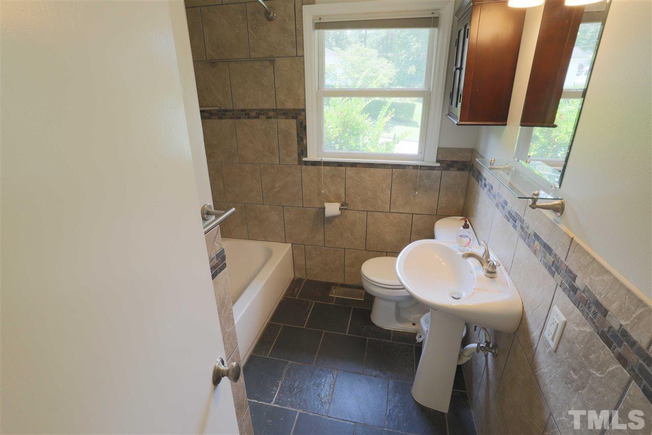 3501 Cranston Road Garner, NC 27529 - Photo 12 of 18 a bathroom with a sink a toilet and mirror
