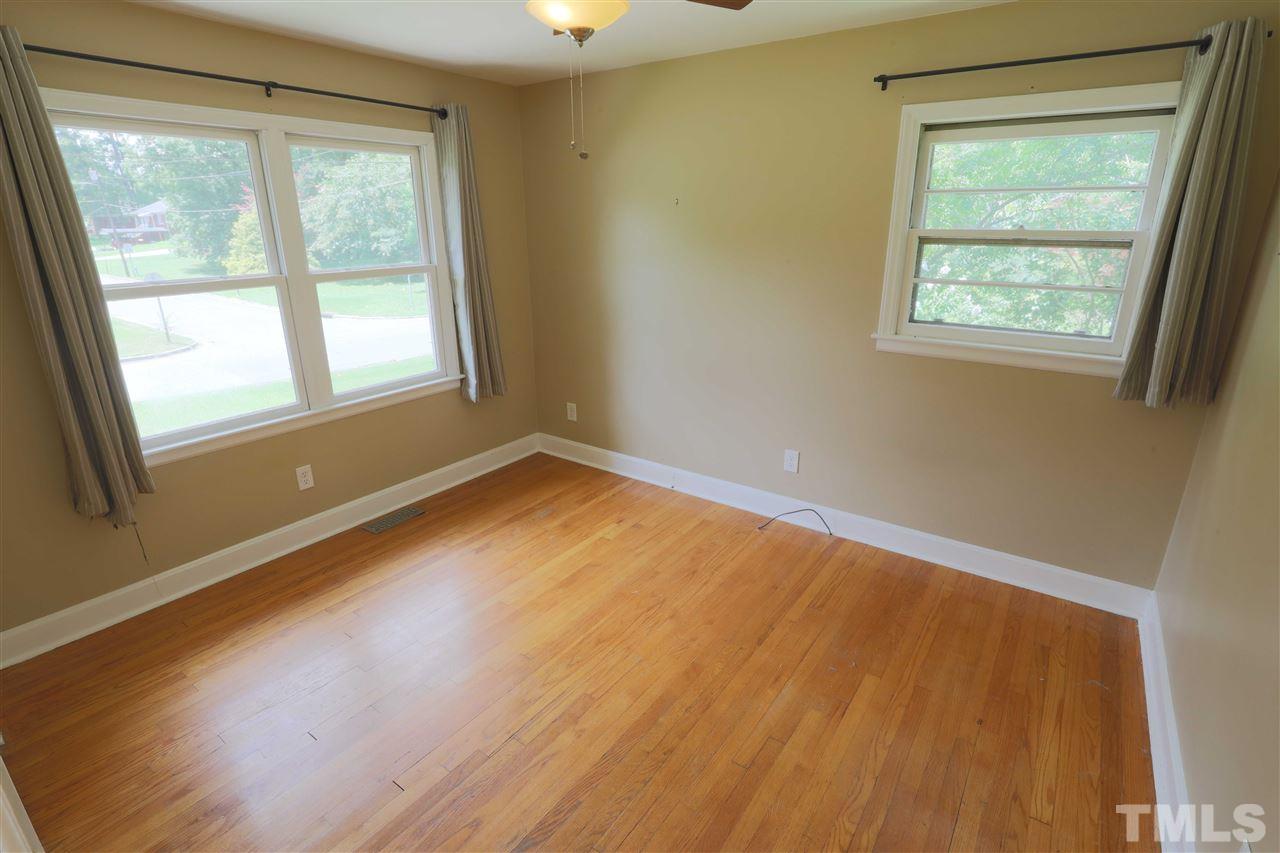 3501 Cranston Road Garner, NC 27529 - Photo 14 of 18 a view of an empty room with wooden floor and a window