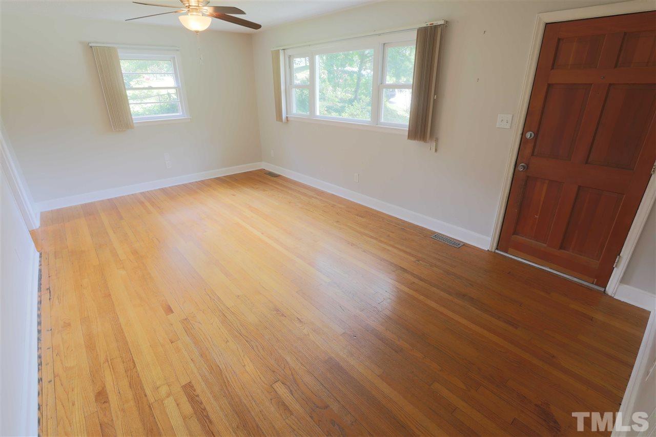 3501 Cranston Road Garner, NC 27529 - Photo 6 of 18 a view of an empty room with wooden floor and a window