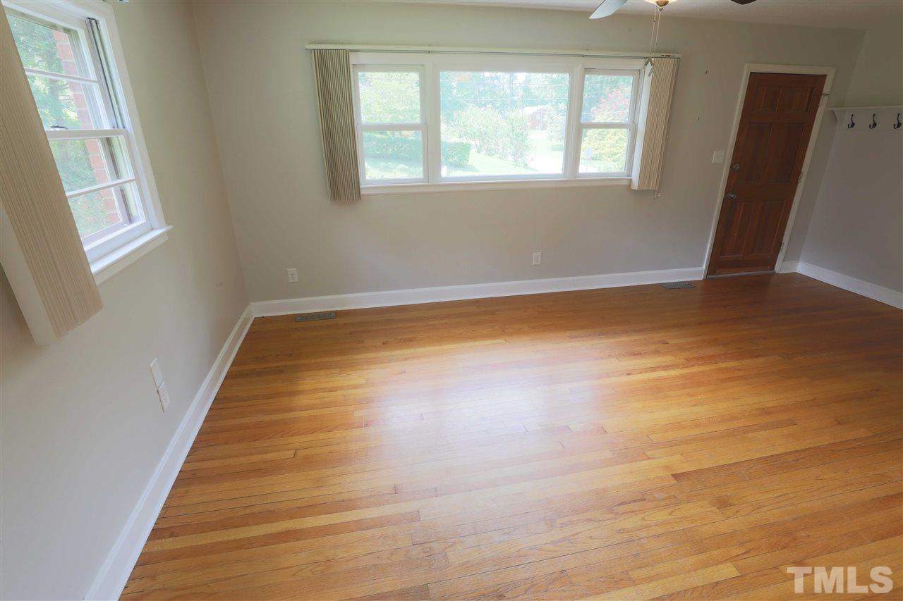 3501 Cranston Road Garner, NC 27529 - Photo 8 of 18 a view of an empty room with wooden floor and a window