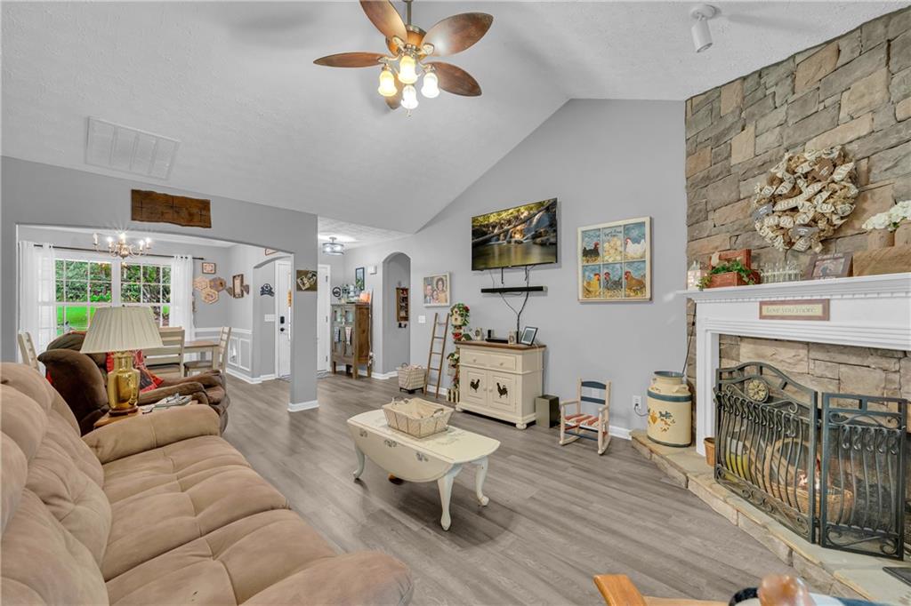 587-j B J B Owens Road Bethlehem, GA 30620 - Photo 28 of 99 a living room with furniture a fireplace and a flat screen tv