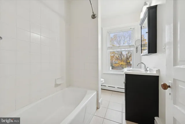 a bathroom with a bathtub and a sink