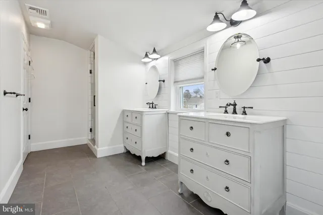 a bathroom with a double vanity sink mirror and vanity