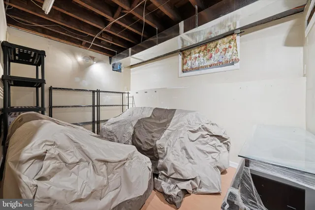 a bed with white sheets and pillows on it